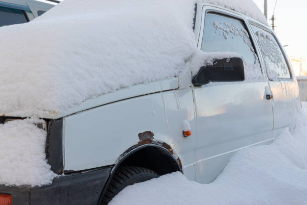 istock old white abandoned broken rusty car parked by the road under a large layer of snow on a bright winter day 1302093675