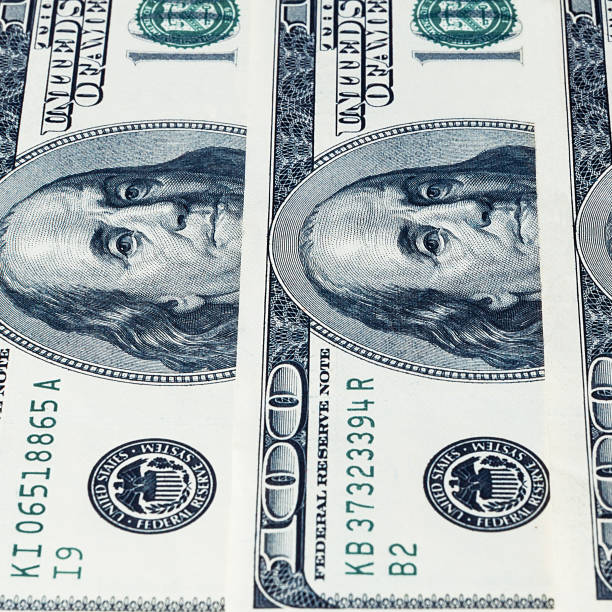 istock Banknotes of dollars are stacked in a row. 1302096217
