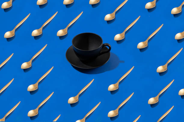 istock Geometry Pattern Made of Teaspoon and a Cup on Blue Background 1302097640