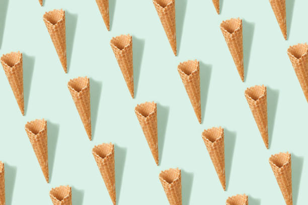 Conceptual still life shooting with ice cream cones on mint green paper background.