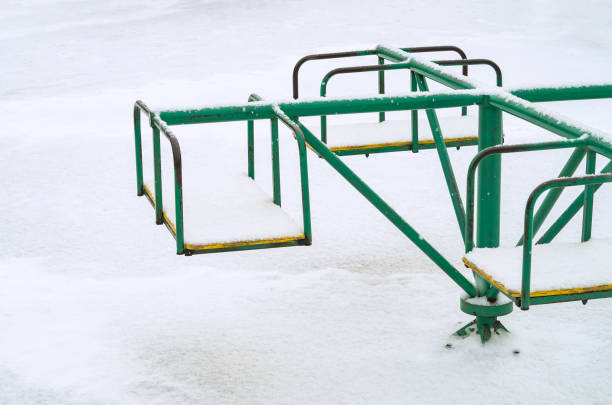 istock Children's carousel under the white snow 1302100576