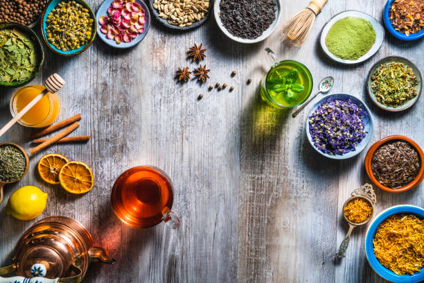 istock Tea and herbal infusion with dried herbs on wooden gray table board 1302103537