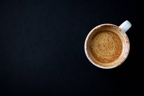 istock Cup of coffee on dark background. Top view. Copy space. 1302103539