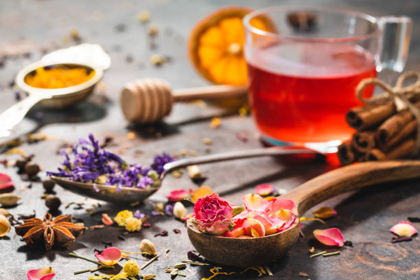 istock Black tea cup and herbal tea featuring rose petals tea and mallow 1302103655