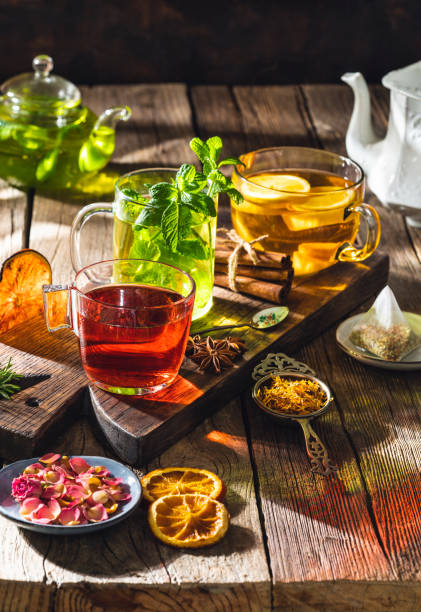 istock Tea and herbal infusion with dried herbs on wooden rustic table board 1302104276