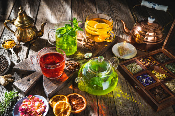istock Tea and herbal infusion with dried herbs on wooden rustic table board 1302104378