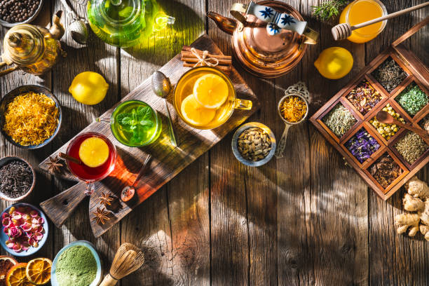istock Tea and herbal infusion with dried herbs on wooden rustic table board 1302104712