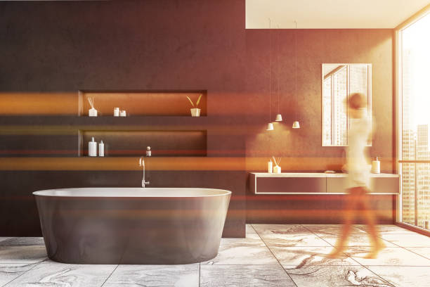 istock Woman walking in gray bathroom 1302108291