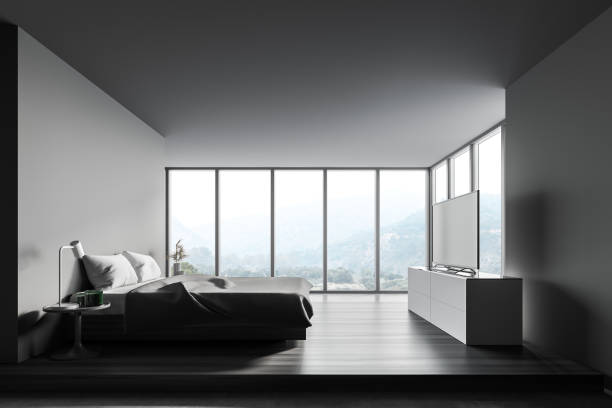 istock Panoramic gray bedroom interior with TV 1302109566