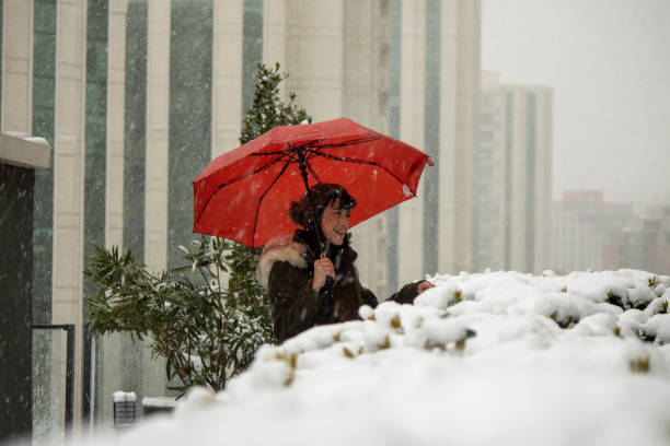 Young woman walking with red umbrella