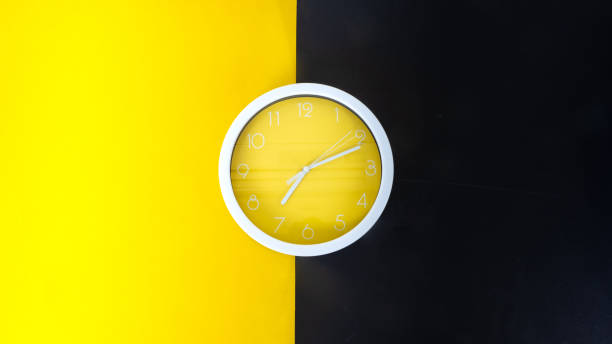 istock Big beautiful stylish clock on yellow and black background, space for text 1302115680