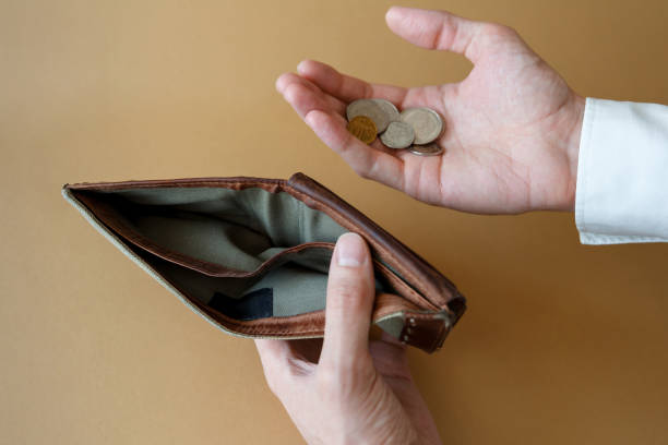 istock Empty wallet in the hands of a man on a plain background 1302117033