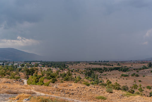 View looking towards the Jezreel Valley from the hill at Beit She'an National Park with rain clouds