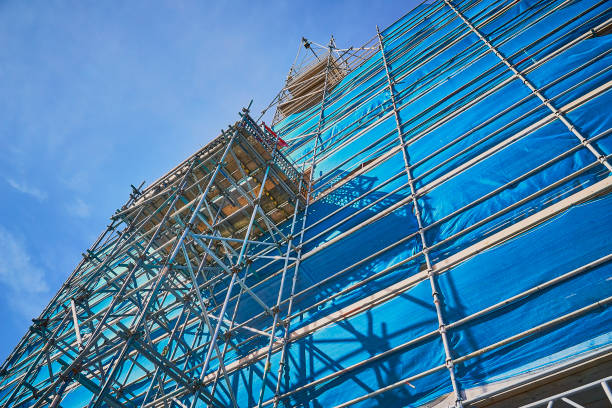 Blue scaffolding with a dark blue sky on sunny day