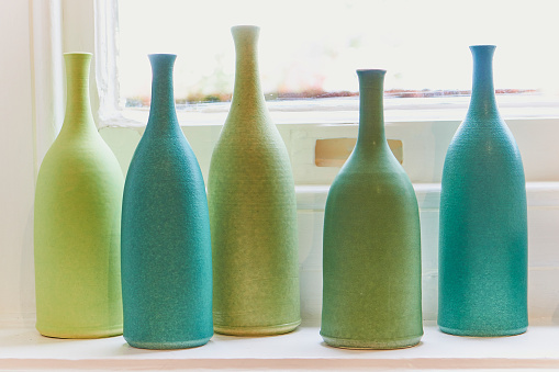 Green and Turquoise bottles on a windowsill