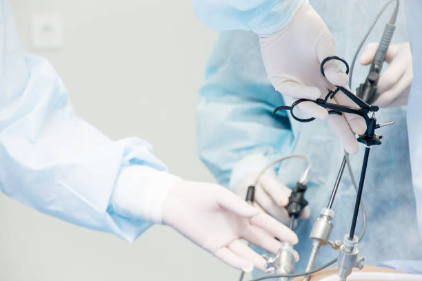 Surgeon performs laparoscopic surgery on the abdomen. Close-up of a laparoscope and doctor's hands stock photo