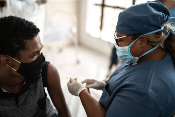 istock Teenager boy being vaccinated - wearing face mask 1302121120