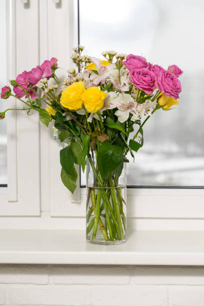 istock Beautiful flowers in vase with light from window 1302121492