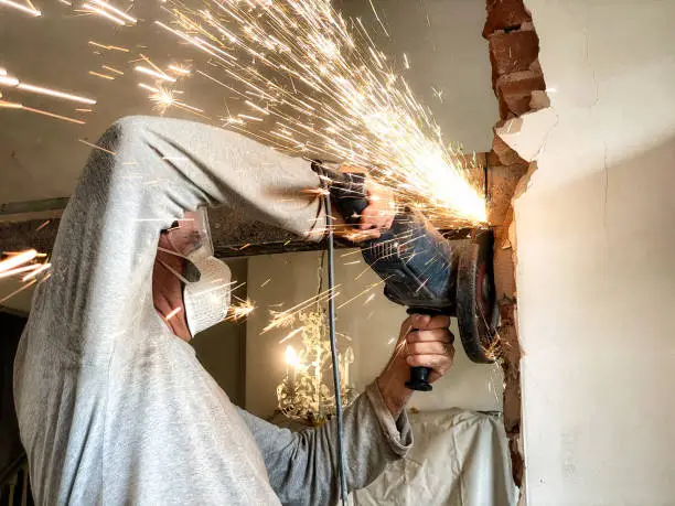 Using angle-grinder to remove beam