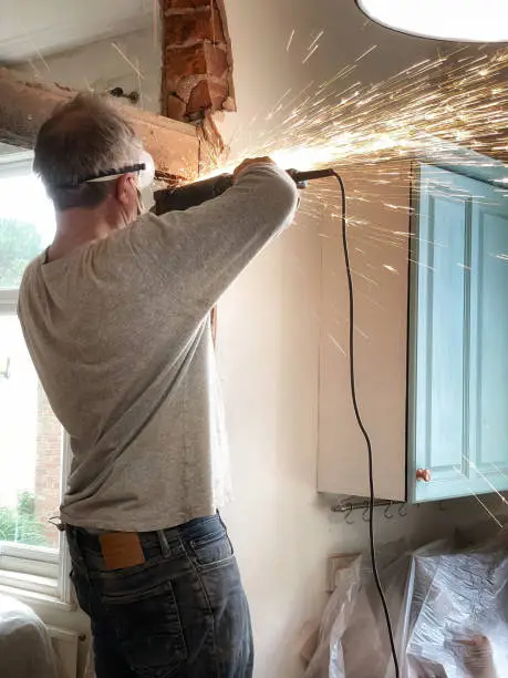 Using angle-grinder to remove beam