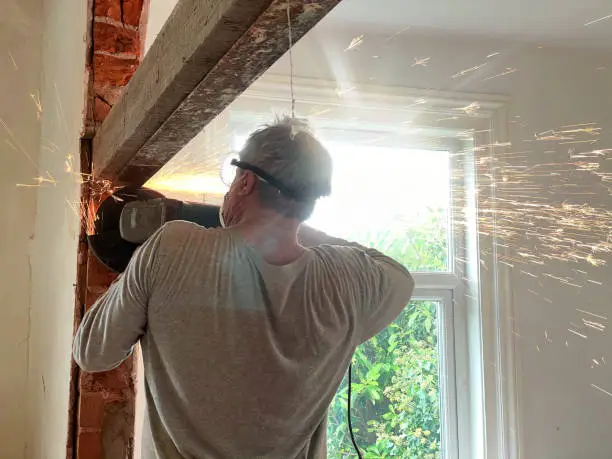 Using angle-grinder to remove beam