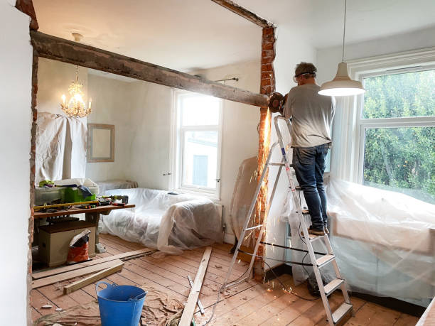 Man removing a metal beam Using angle-grinder to remove beam wall renovation stock pictures, royalty-free photos & images