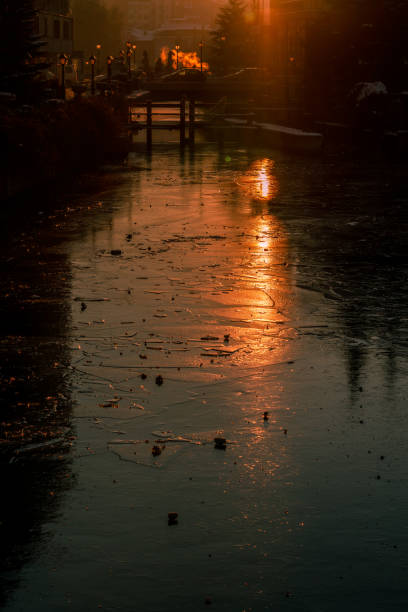 Sunrise over frozen river. Beautiful vertical landscape.