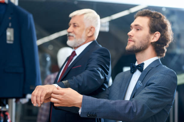 istock Two elegant men choosing costumes. 1302124563
