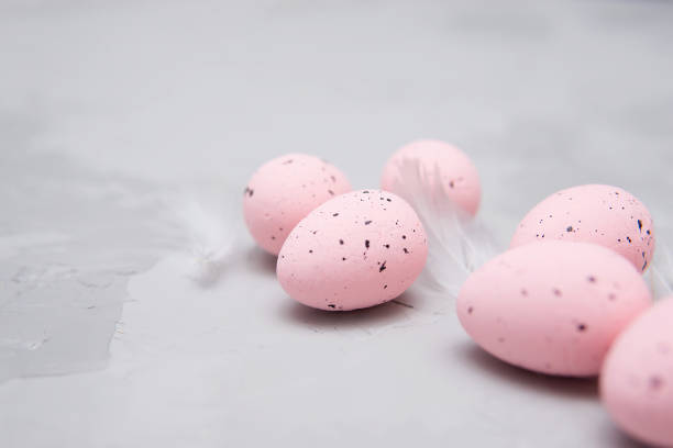 istock Easter background, pink quail eggs on gray background, flat lay, empty space for text. Happy Easter holiday 1302124965