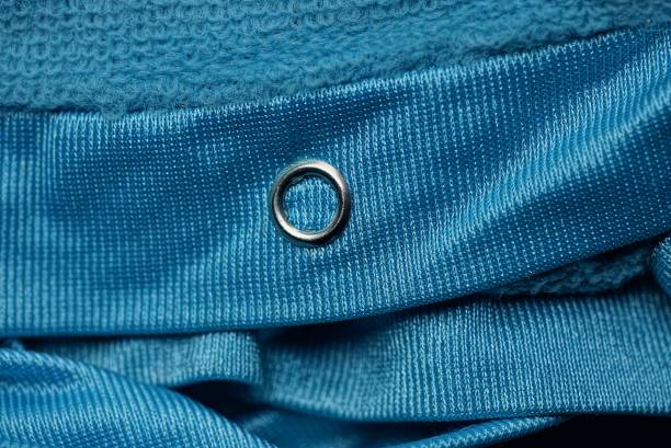 istock small metal button rivet on blue fabric 1302126023