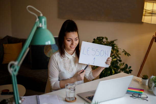 istock Professor using computer and teaching her students online from home. stock photo 1302126139