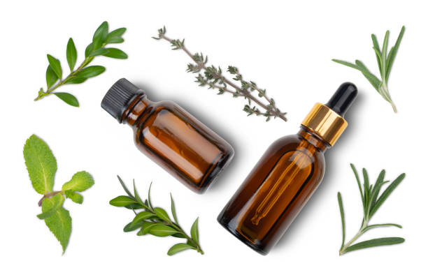 istock Isolated on white background Dropper bottles with oil and herbs on white table flat lay view. Herbal cosmetics concept 1302127598