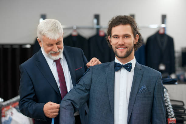 istock Happy client fitting fashionable suits. 1302127873