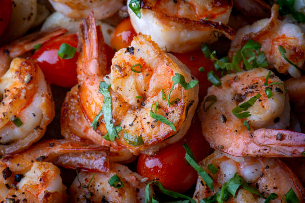 istock Grilled spicey shrimps with seasoning. 1302128578