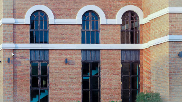 istock Old and vintage red brick wall with windows fram. 1302129274