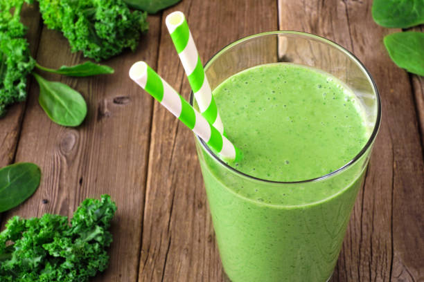 istock Green smoothie with kale and spinach, close up on a wood background 1302130218