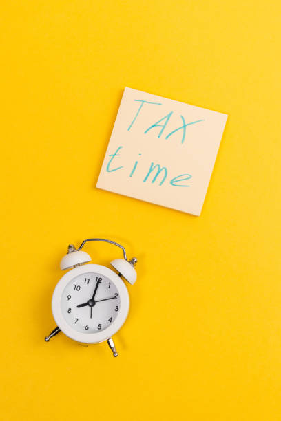 istock Tax time flat lay composition on yellow background. copy space. vertical photo 1302131262
