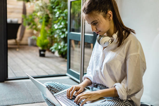istock Young woman is using laptop at home 1302132499