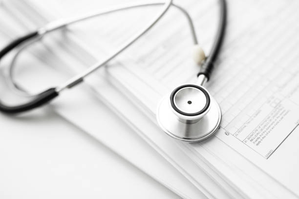 istock Stack of report medical documents and stethoscope isolated on white background 1302132981