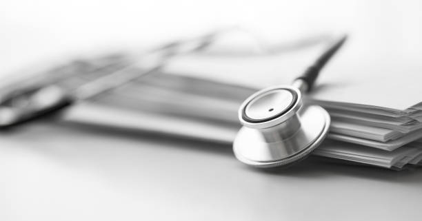 istock Stack of report medical documents and stethoscope isolated on white background 1302132987