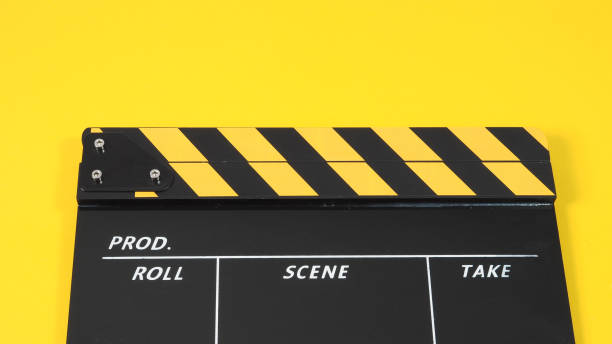 istock clapper board or movie clapperboard or slate on yellow background. 1302135309