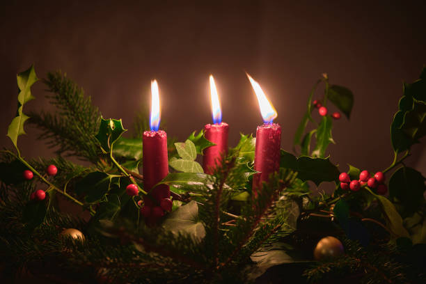 Christmas decoration with red candles and foliage stock photo