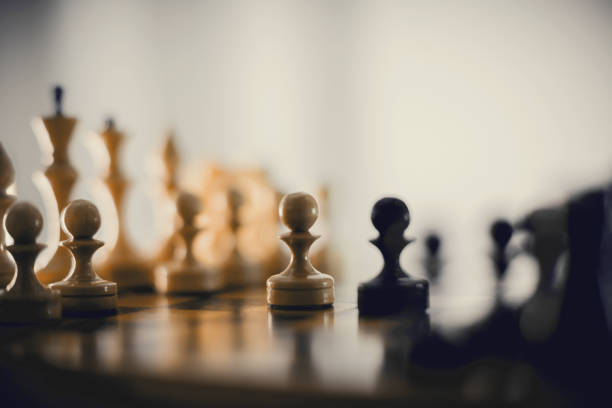 istock Two chess pieces are pawns: black and white. 1302136042