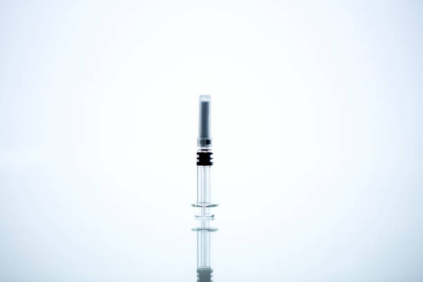 Coronavirus Covid 19 vaccine concept (own design, not real product) - syringe with reflection,  closeup detail.Horizontal composition with copy space. Shot with dslr camera, canon 5dsr