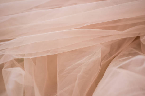 istock delicate soft beige fabric abstract background close up 1302140193