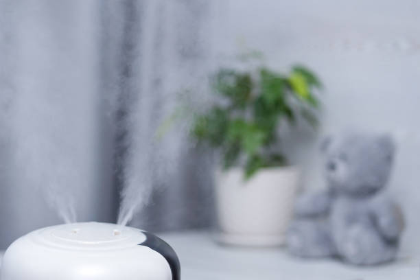 istock Air humidifier on table in children's room. Copy space. 1302140527