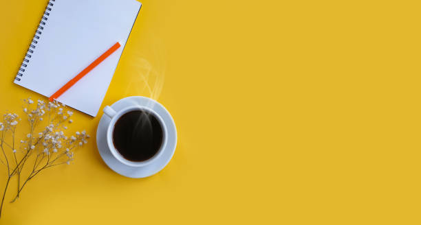istock notebook, cup of coffee on a colored background 1302140741