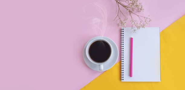 istock notebook, cup of coffee on a colored background 1302141734