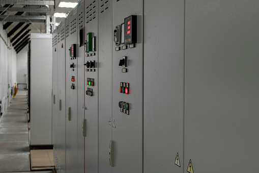 Power plant electrical substation gear shifting, industrial electrical panel, substation control, security and protection systems. Selective focus.