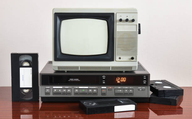 istock Old silver vintage TV with VCR on wallpaper background. 1302144642